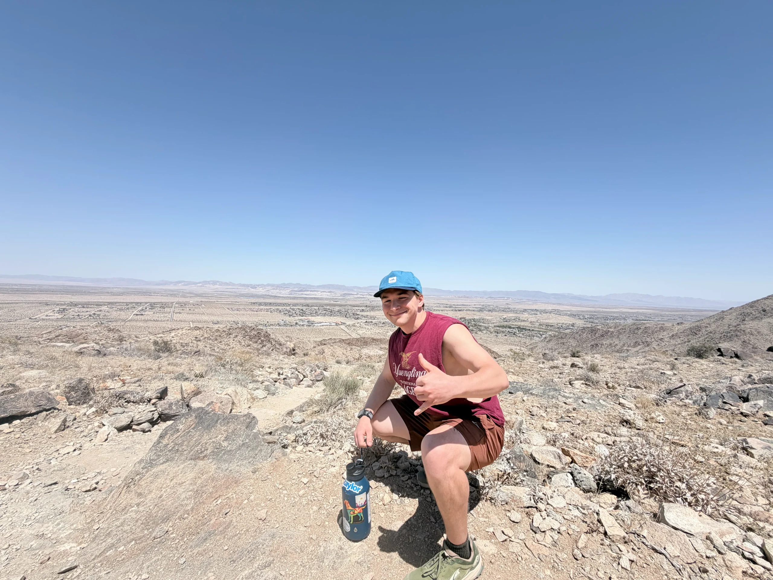 Frank posing on a hike with the vast mountain range in the background
